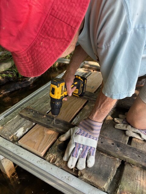 man working on pier boards