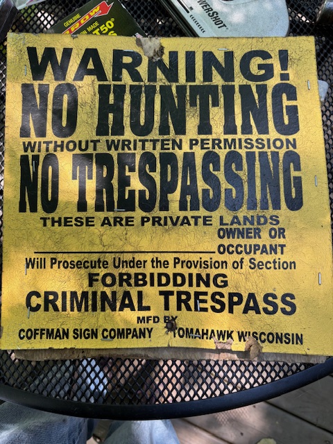 photo of a sign that says, Warning ! No hunting No trespassing
