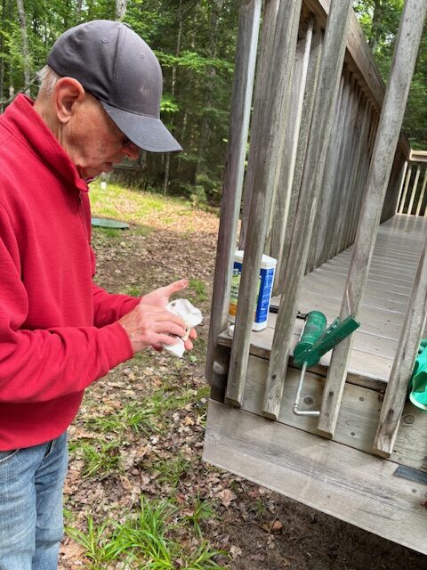 photo of man working on roof shingle