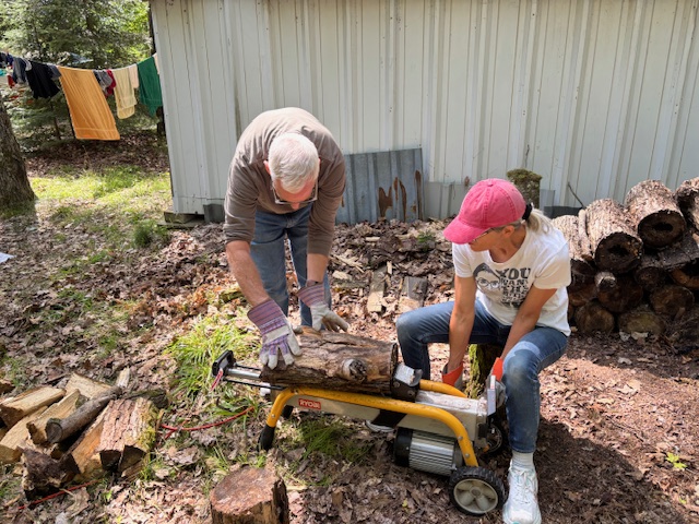 man and woman using a log splitter
