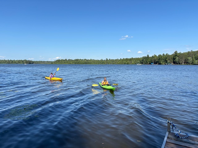 two women in kayaks on lake
