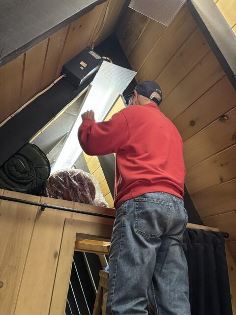 man cleaning lights