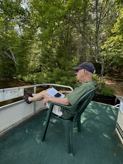 man reading on barge