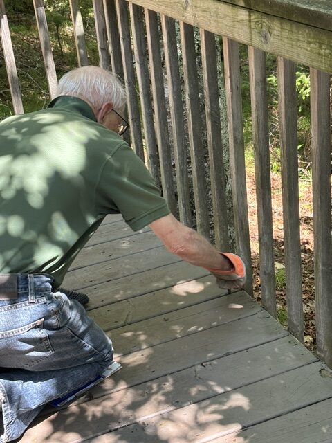 man cleaning deck