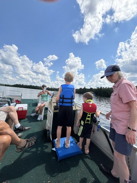boys driving boat
