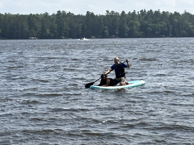 boy and dog on paddleboard