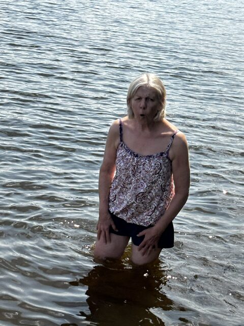 woman wading in lake