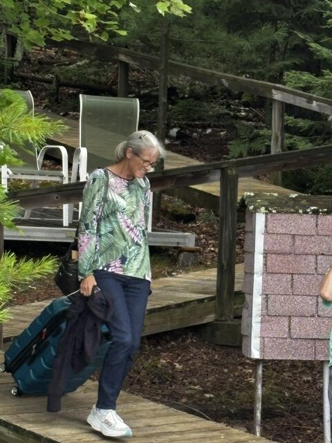 woman taking suitcase to boat