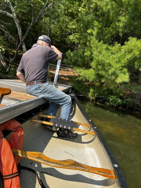 man docking canoe